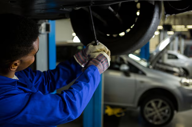 mechanic-fixing-car-tyre_1170-1654 mechanic-fixing-car-tyre_1170-1654